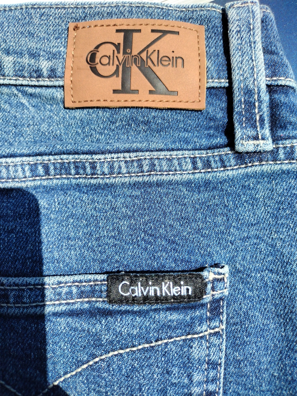 Calvin Klein Women's Medium Blue Denim Jeans with Leather Logo Patch